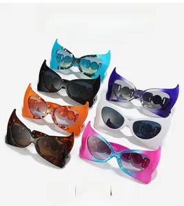 Detail of bat-wing shaped sunglasses in seven colors with metal hinge accents
