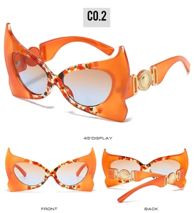 Detail view of devil bat sunglasses with orange tortoiseshell frames and gradient lenses