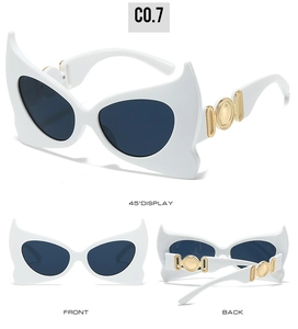Detailed view of white bat-wing sunglasses with gold metal accents and dark grey lenses
