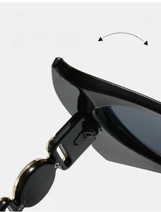 Detail of durable texture hinge with golden metallic disc on black fashion sunglasses