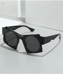 Macro detail of irregular black sunglasses showing textured material and CE markings