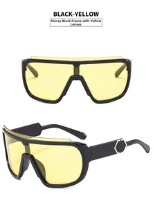 Detail view of black-yellow sports sunglasses with metallic hexagonal temple accents