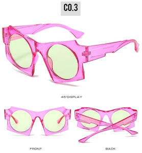 Three-way view of irregular pink geometric sunglasses with green lenses and UV protection