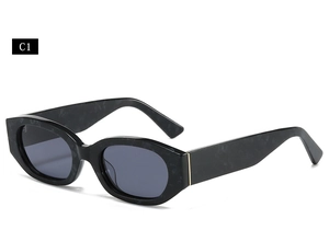 Close-up of black textured oval sunglasses with wide temples and dark UV lenses