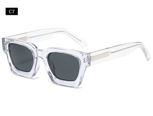 Detail of transparent square sunglasses with golden metal inner core and grey lenses