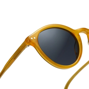 Retro amber oval thick frame sunglasses with dark lenses and metal stud details