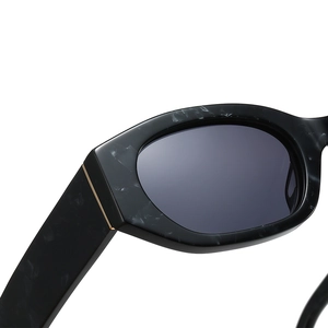 Trendy irregular sunglasses with black marble acetate frames and gold metal accents