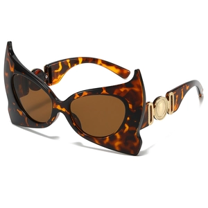 Tortoiseshell bat-wing sunglasses with brown lenses and gold metal temple accents
