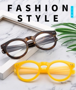 Detail view of tortoiseshell and yellow retro round frames with stylish metal rivet accents
