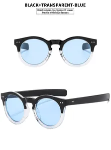 Detail view of round vintage sunglasses featuring black and clear frame with blue lenses