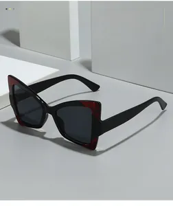Détail de lunettes de soleil papillon avec motifs écailles et verres gris foncé