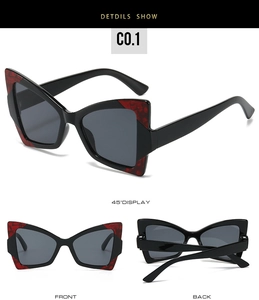 Détails des lunettes papillon noires avec accents marbrés rouges et verres gris foncé