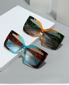 Close-up of tortoise shell square glasses frames with gradient lenses on a pedestal