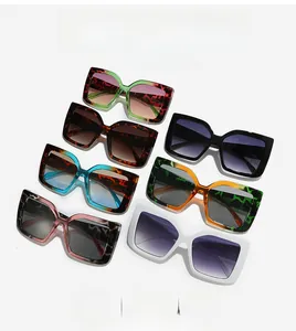 Flat lay of retro oversized rectangular sunglasses in seven assorted gradient colors