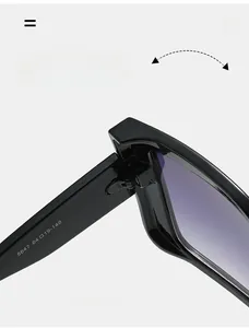 Detail view of durable metal hinges and gradient lenses on oversized black sunglasses
