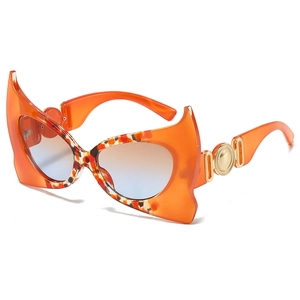 Chic orange devil bat sunglasses with tortoise pattern and gold metal temple detail