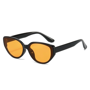 Cat eye sunglasses with black glossy frames and orange lenses at a 45-degree angle