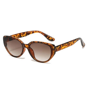 Chic leopard print cat eye sunglasses with brown gradient lenses on white background