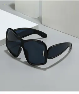 Close-up of black oversized frame sunglasses with integrated nose pads and silver accents