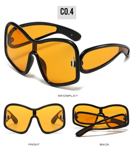 Three-angle view of oversized Y2K sunglasses with black frames and orange lenses