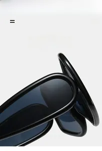 Detail of ultra-light black Y2K wraparound sunglasses showing flexible elastic frame
