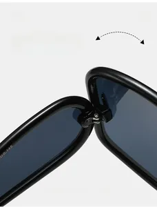 Macro shot of reinforced metal hinges and frame temple measurements on black Y2K sunglasses