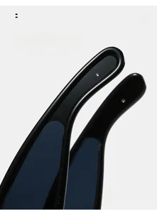 Detail view of glossy black Y2K sunglasses curved mirror legs for comfort