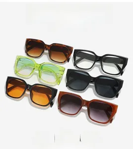 Flat lay of oversized square sunglasses in various colors like tortoise and neon green
