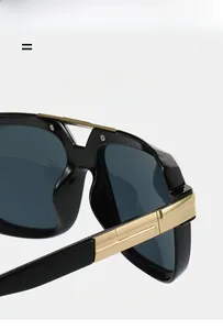 Detail of retro square sunglasses with gold metal accents and sleek black bridge design