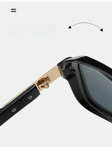 Detailed macro view of durable gold metal hinges on square black sunglasses frame