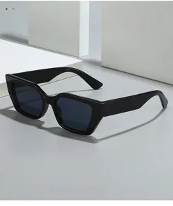 Detail of black bold cat-eye sunglasses featuring chunky polygonal frames and dark lenses