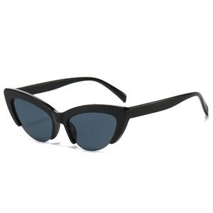 Retro cat-eye sunglasses with thick black frames and dark blue lenses in a modern style