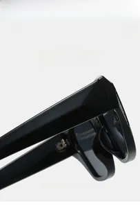 Detail view of glossy PC frame sunglasses with wide temples and lightweight texture