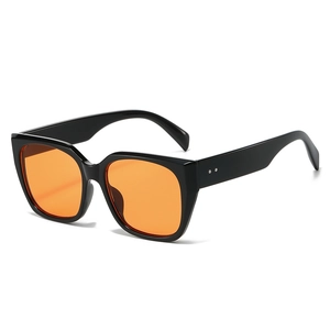 Chic black oversized square sunglasses with translucent orange lenses and silver rivets