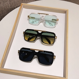 Three pairs of vintage square sunglasses with thick frames and gold metal accents