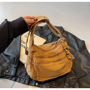 Detail of vintage yellow canvas tote with three zipper pockets and wide shoulder strap