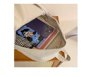 Interior view of beige corduroy backpack showing large capacity for daily essentials