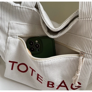 Detailansicht einer Cord-Einkaufstasche mit TOTE BAG Stickerei und Reißverschlussfach