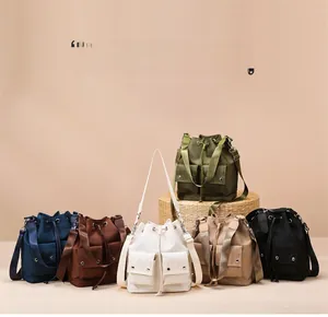 Collection of multi-color drawstring nylon shoulder bags with dual front pockets
