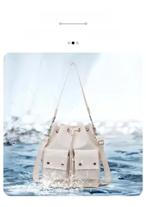 Detail of waterproof nylon drawstring bucket bag showing water splashing on the surface