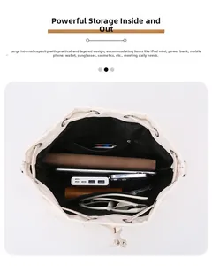 Top view of spacious cream nylon bucket bag interior with items and zipper pocket