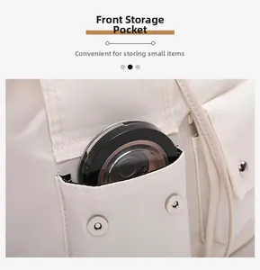 Macro detail of the front pocket with metal snap button on cream nylon shoulder bag