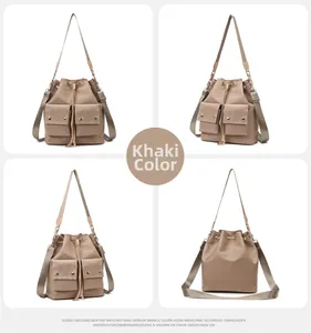 Detail view of khaki nylon bucket bag with drawstring closure and two front flap pockets