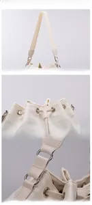 Detail view of reinforced stitching and adjustable drawstring on cream nylon bucket bag
