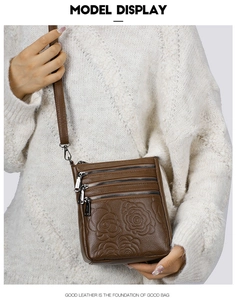 Brown leather crossbody bucket bag with floral embossing and multi-zipper detail