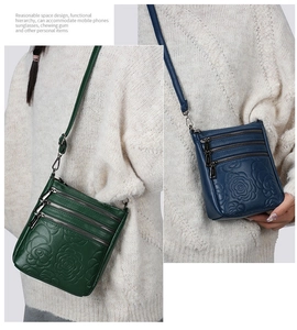 Close-up of embossed floral leather bags with multiple functional zippers and compartments