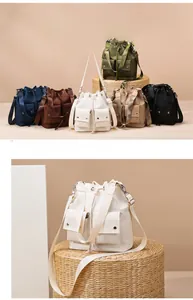 Macro detail of high-capacity nylon drawstring bucket bags with dual front pockets