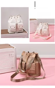 Detail of drawstring bucket bags with flap pockets and wide fabric shoulder straps