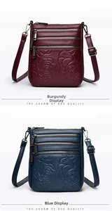 Detail of embossed floral patterns and multiple zippers on burgundy and blue bucket bags