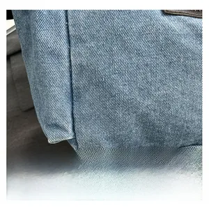 Close-up of indigo denim fabric texture showing premium twill weave and durable material